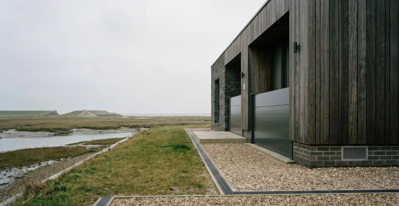 Resilient UK home protected by flood defenses in high-risk zone demonstrating insurance coverage
