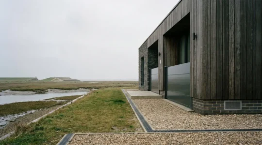 Resilient UK home protected by flood defenses in high-risk zone demonstrating insurance coverage